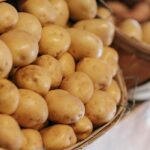 Rustic baskets filled with fresh potatoes at a local market stall, highlighting raw, healthy produce.